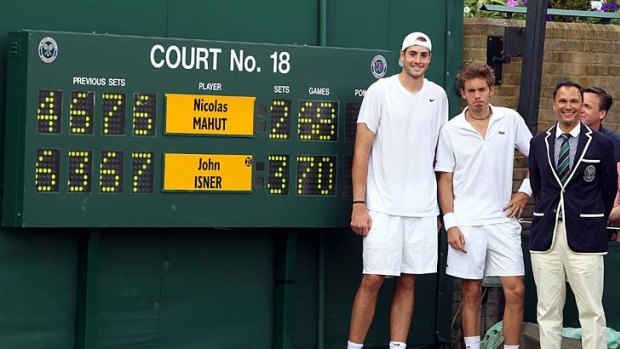 John Isner and Nicolas Mahut with chair umpire Mohamed Lahyani after playing the longest match in Grand Slam history at WImbledon in 2010.