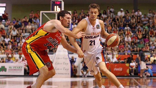 Daniel Johnson of the 36ers drives to the basket.