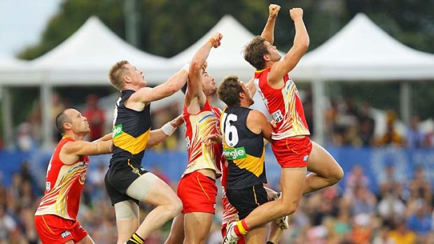 Hands up: Gold Coast and Richmond players fly for the ball during the Suns' thrilling win in Cairns yesterday.