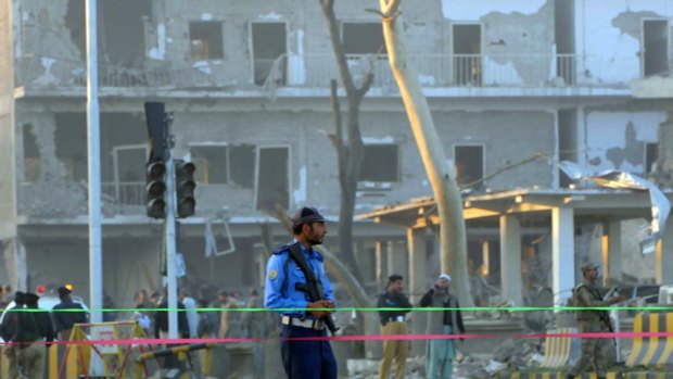 Pakistani security officials secure the bomb blast site at the Inter-Services Intelligence building in Peshawar.