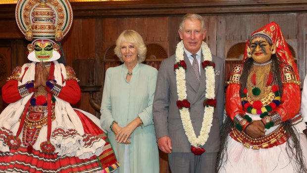 Prince Charles and the Duchess of Cornwall pose with dancers in Kochi, India on November 11.