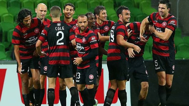 Happy Wanderers: Western Sydney players celebrate a goal in their 3-1 win over Melbourne Heart.