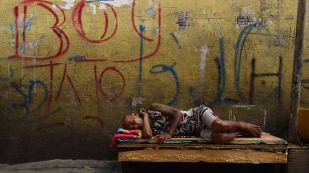 A man sleeps on a makeshift bed in one of the alleys in Tondo district in Manila, Philippines. 
