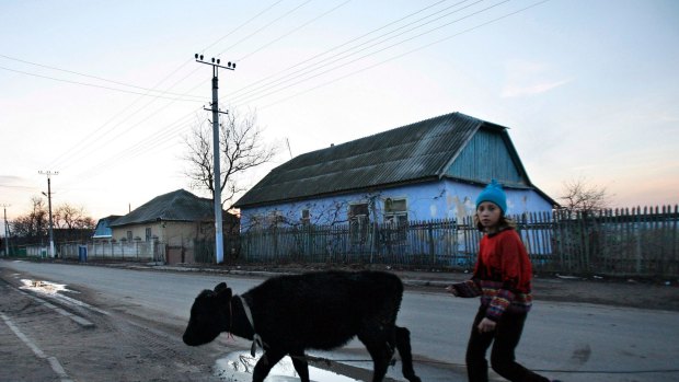 Remote: A young girl walks along a main road in the village of Cosnitsa, Moldova. Transnistria is in a quandary: while it calls itself a country, no one else does.