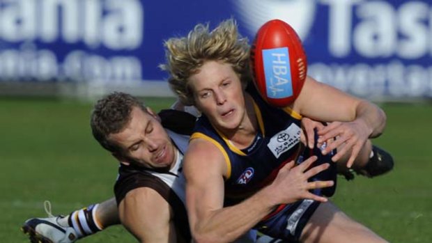 Hawthorn's Rick Ladson tackles Adelaide's Rory Sloane.