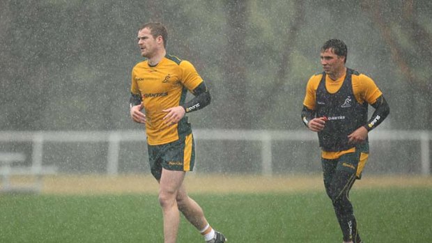 Training and raining: Wallabies Pat McCabe and Nick Phipps gear up for a wet Tri Nations opener.