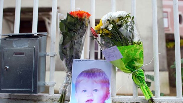 Tribute ... flowers and a picture of three-year-old child Bastien were left at the entrance of the child's home.