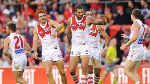 Lance Franklin celebrates a goal with his teammates.