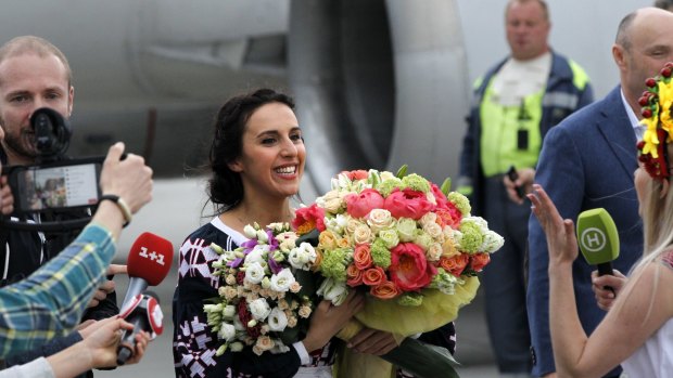 Sweet victory: Ukraine's Jamala holding bunches of flowers upon her arrival at Borispil international airport outside in Kiev.