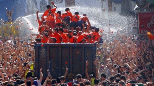 Crowds of people throw tomatoes at each other during the annual "tomatina" festival in Bunol, Spain.