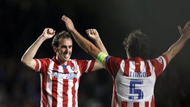 Atletico Madrid's Uruguayan defender Diego Godin (L) and Atletico Madrid's Portuguese midfielder Tiago Mendes .