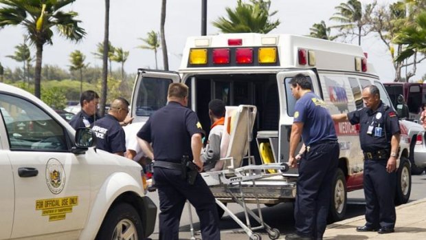A 16-year-old boy who stowed away on a flight from California to Hawaii is loaded into an ambulance.