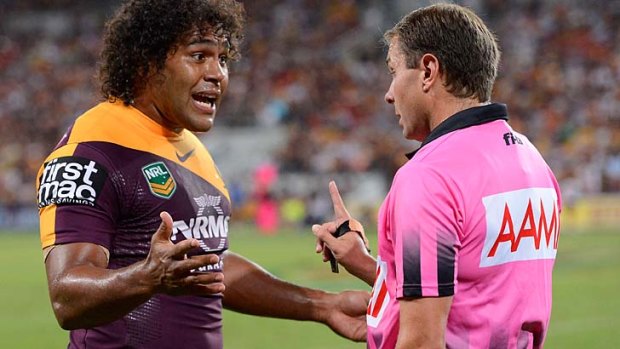 Risky business: Sam Thaiday touches referee Adam Devcich as he disputes a decision on Friday night.