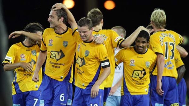 A jubilant Jason Culina of Gold Coast United celebrates with team mates after scoring.