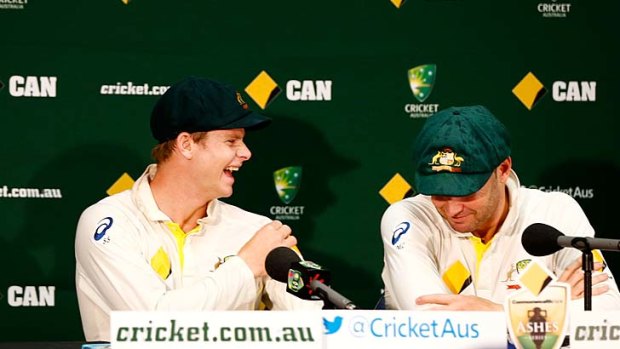 Steve Smith and Michael Clarke of Australia speak at a press conference after defeating England in Perth.
