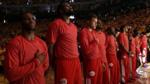 The Clippers protest with their shirts inside out as they listen to the national anthem before the game.