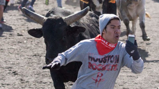 Christian takes a selfie video while running away from a bull.
