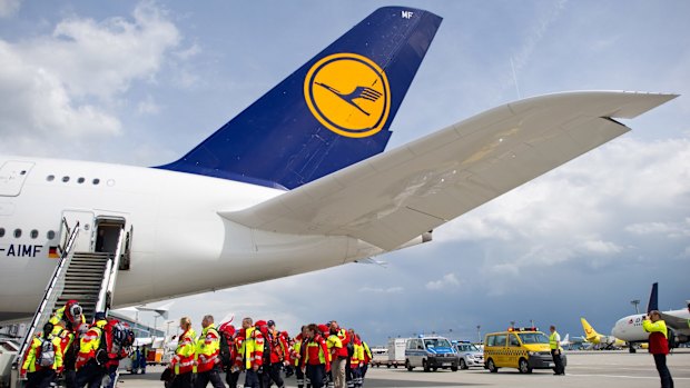 Members of a German rescue organisation board a plane at the airport in Frankfurt for Nepal. 