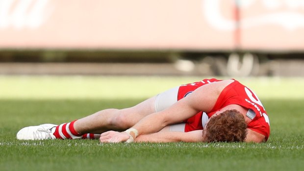 Gary Rohan of the Swans was knocked out after falling heavily.