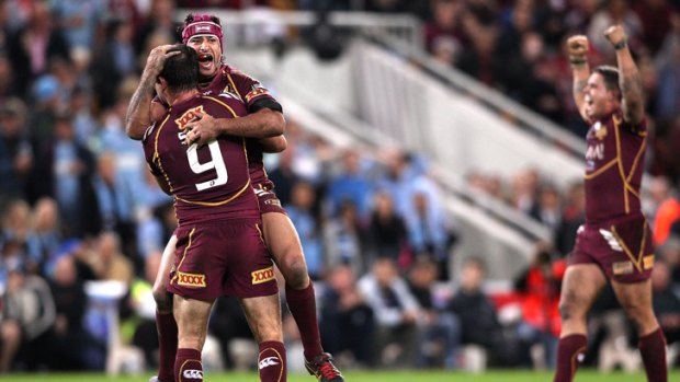 Johnathan Thurston and Cameron Smith of the Maroons celebrate victory.