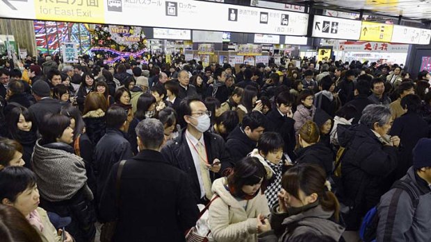 Passengers gather after train services were suspended following an earthquake at Sendai station in Sendai, Miyagi prefecture.