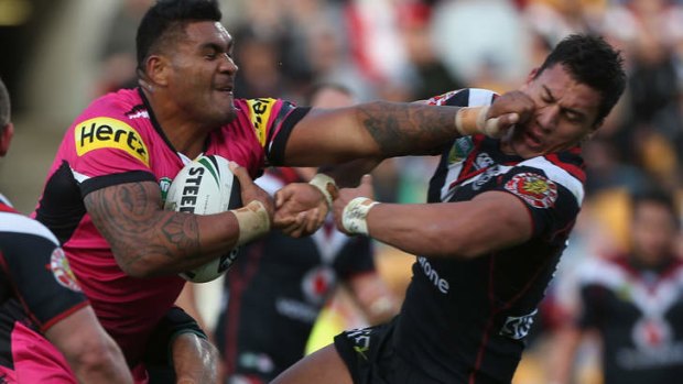 Bruising encounter: Mose Masoe of the Panthers fends off Elijah Taylor of the Warriors.