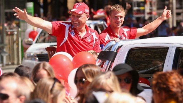 Sydney coach John Longmire and captain Kieren Jack wave to the crowd during the parade.