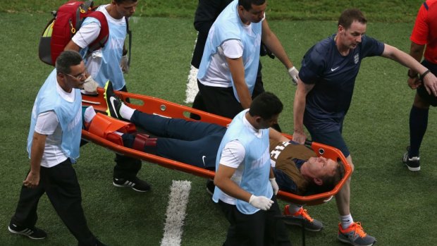 World Cup over: England trainer Gary Lewin is stretchered off the field.
