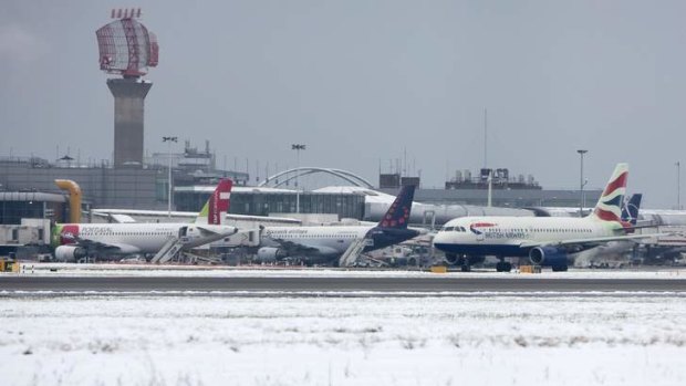A British Airways aircraft taxis after snowfall at Heathrow airport.