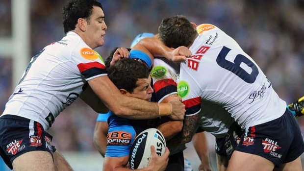 Greg Bird of the Titans is shut down by the Roosters defence at Suncorp Stadium.