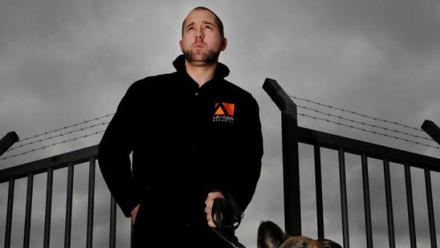 Leader Security canine handler Brad Paul with his dog.