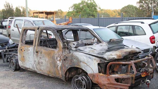 The burnt out police car.