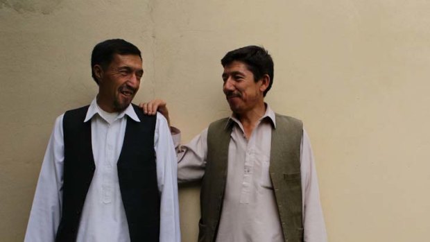 Easing the tension ... Mohammad Akbar Sohrabi, right, shares a tender moment with his cousin, Abdul Rahman Sohrabi,  in Kabul.