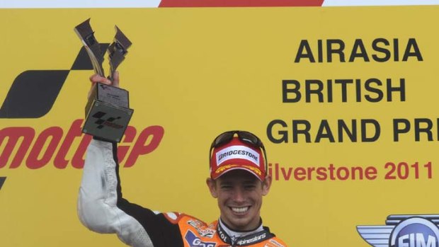 Casey Stoner celebrates after winning the British motorcycling Grand Prix at Silverstone.