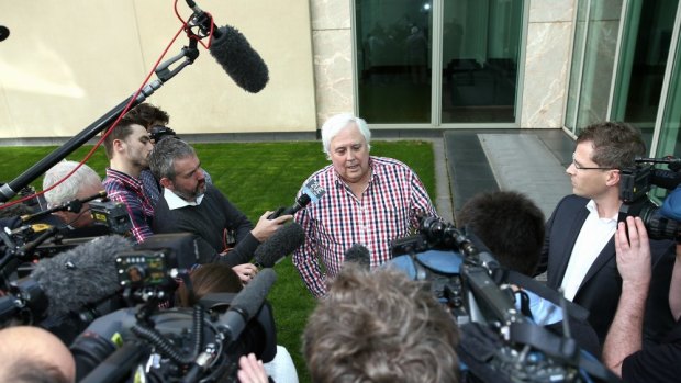 Palmer United Party leader Clive Palmer addresses the media in the Senate courtyard.