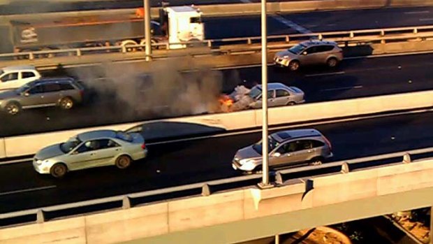 The burning car on the freeway.