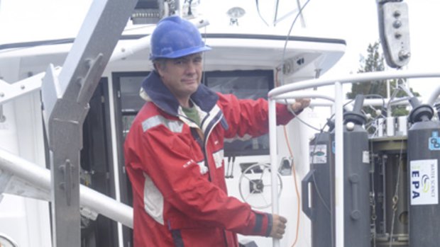 Marine scientist Dr Peter Davies use an oceanographic water sampler in their habitat mapping program.