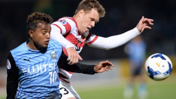 Tight tussle: Western Sydney's Daniel Mullen (right) fights for the ball with Kawasaki Frontale forward Renato.