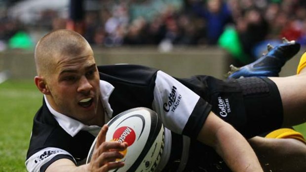 Drew Mitchell of the Barbarians celebrates scoring a try.
