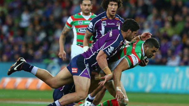 Greg Inglis of the Rabbitohs is tackled by Jesse Bromwich of the Storm in last season's fixture.