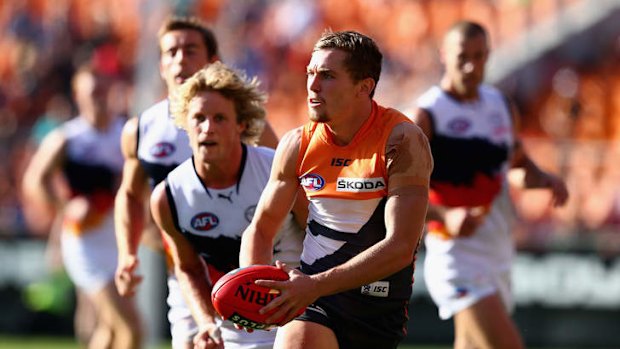 Seeking support: Devon Smith of the Giants looks up field as Crows players approach at Skoda Stadium on Saturday.