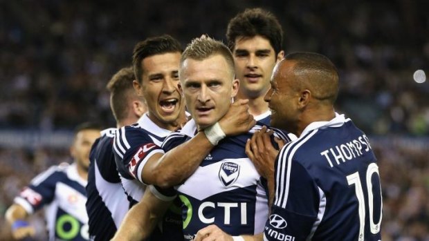 Welcome: Albanian striker Besart Berisha is mobbed by teammates after scoring Victory’s second goal. 