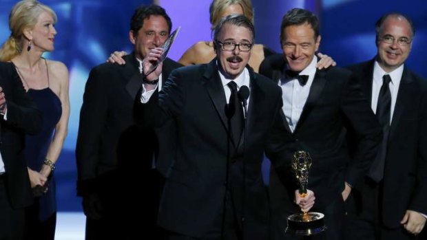 <i>Breaking Bad</i> executive producer Vince Gilligan, next to Bryan Cranston, accepts the Emmy award for Outstanding Drama Series.