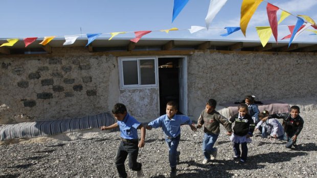 Uncertain future: Bedouin children play outside a school built of mud and car tyres on the West Bank that is likely to be demolished.