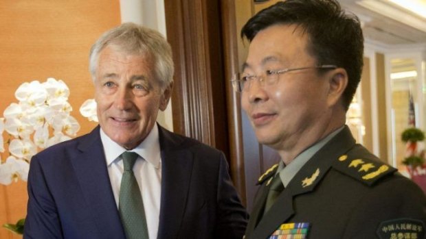 Tense: US Defence Secretary Chuck Hagel meets with People's Liberation Army Lieutenant-General Wang Guanzhong in Singapore. 