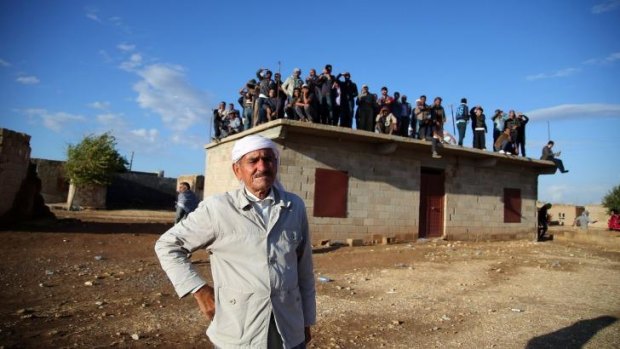 Residents of the border village of Alizar keep guard.