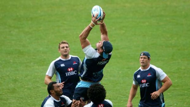 Ben Mowen takes a high ball during a Waratahs training session at the SFS yesterday.
