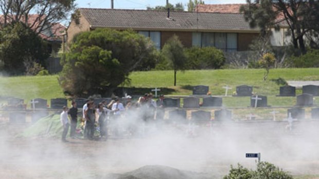 Smoke from burnouts at the funeral for road crash victim Aaron Bryce at a Warrnambool cemetery.