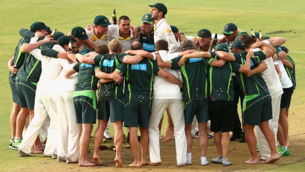Sing it loud: Nathan Lyon leads the victory song as Australia's players celebrate on the WACA pitch.
