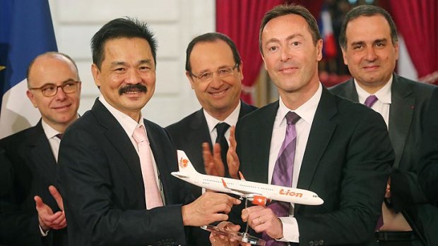 Biggest civilian deal in the history of Airbus ... CEO of Lion Air Rusdi Kirana of Indonesia, left, and CEO of Airbus, Frenchman Fabrice Bregier, right, with France's President Francois Hollande.